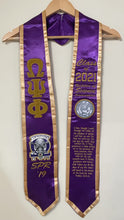 Load image into Gallery viewer, Purple and gold stoles with Omega Psi Phi symbols and text on a wooden hanger.